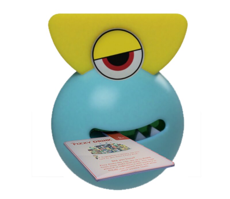 A game card being fed into the Sugargotchi's mouth for analysis