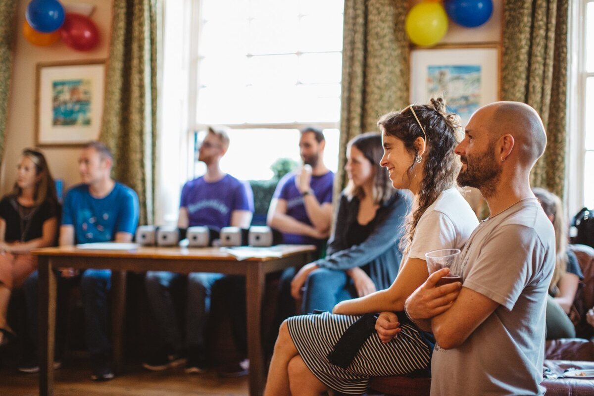Audience members watching and listening during the VR100 performance