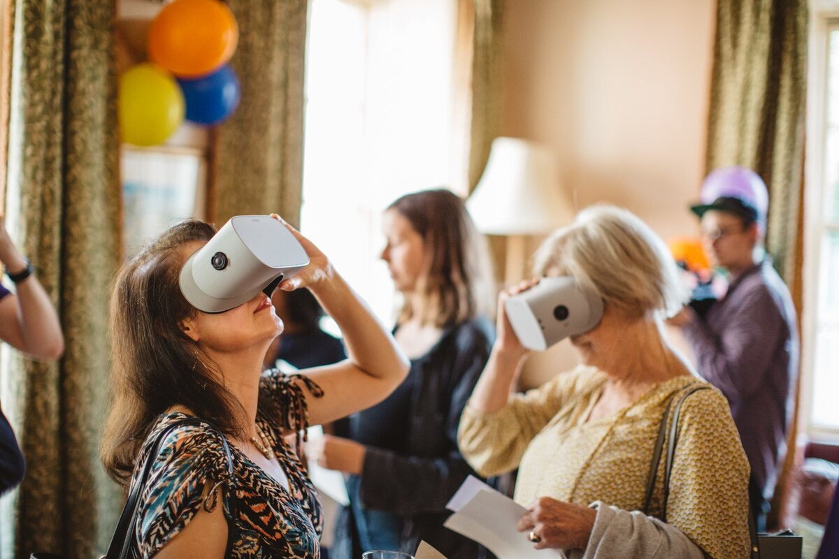 Guests gathered around balloons and decorations at the immersive birthday party